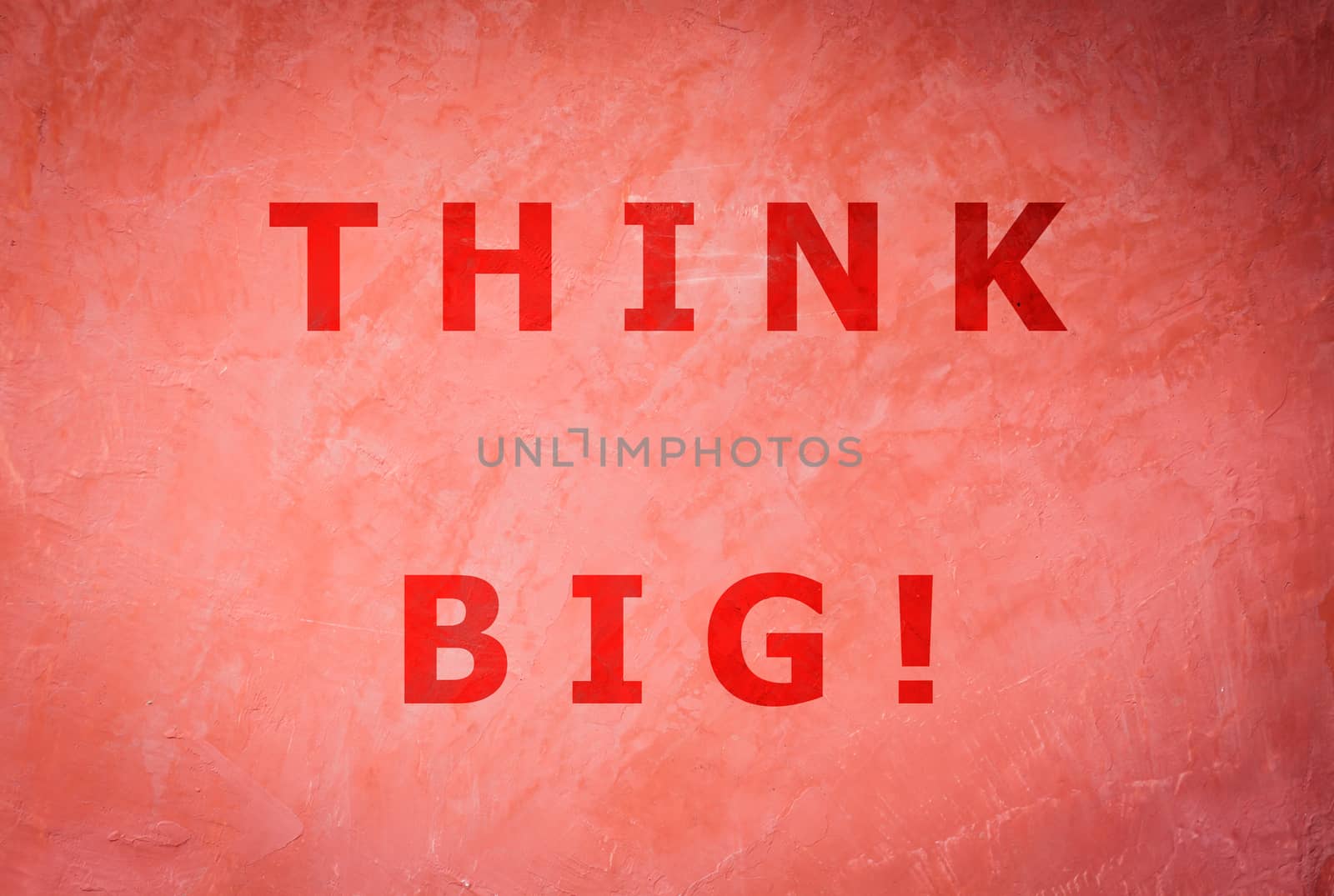 Think big word inspirational quote on handmade creative red wall background