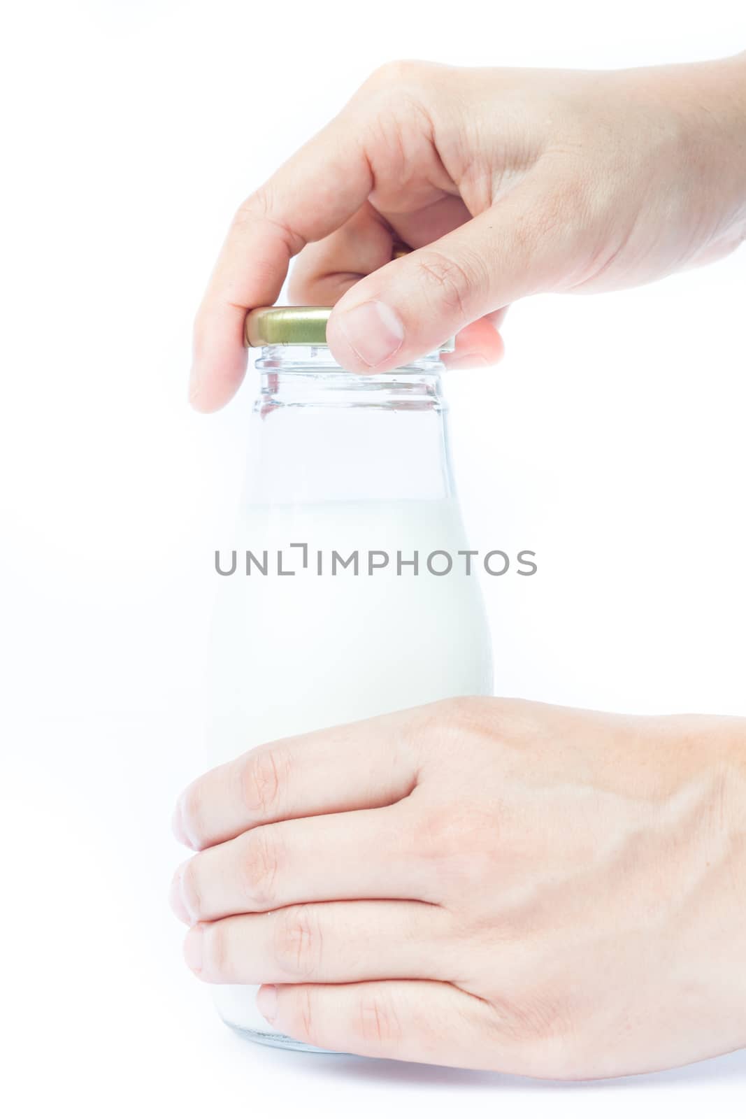 Woman hand open traditional glass milk bottle, stock photo