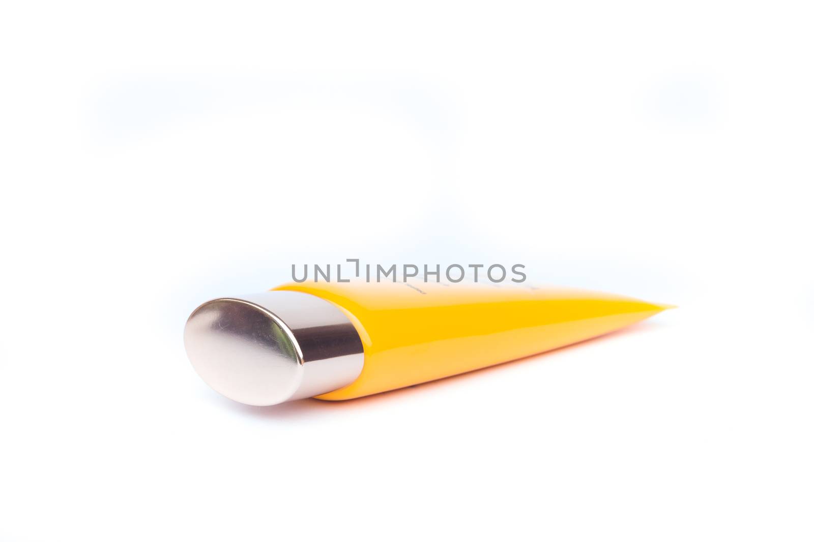 Tube container of sun cream on white background