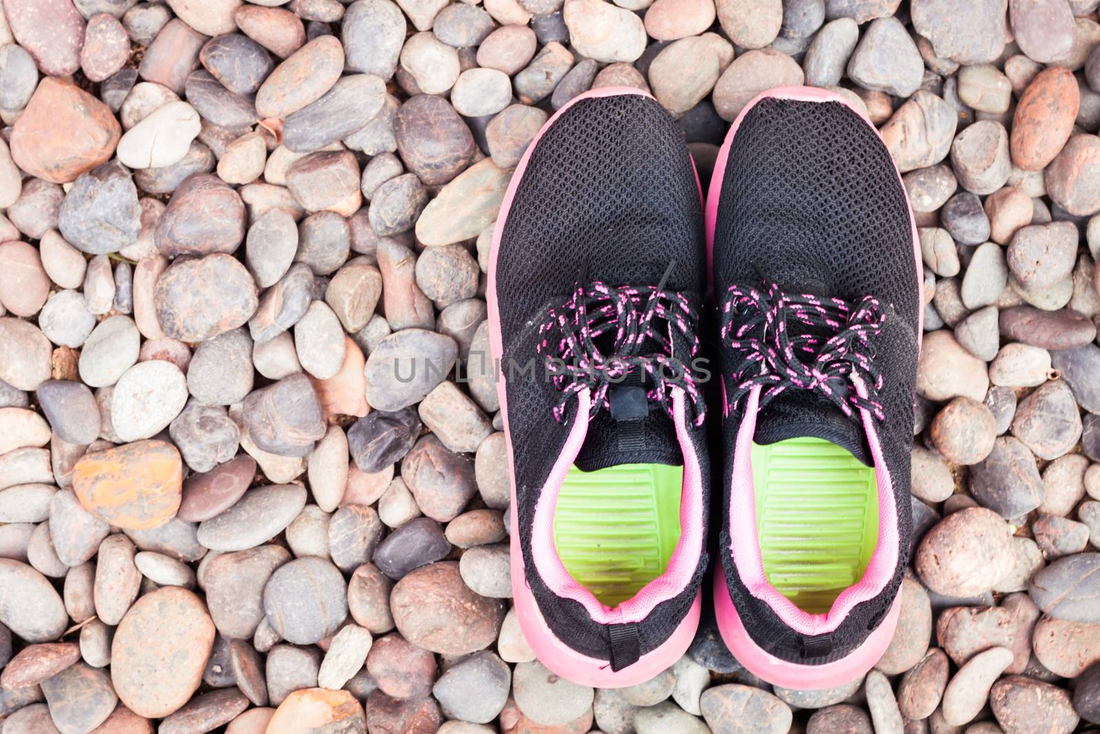 Running shoes in home garden on pebbles, stock photo