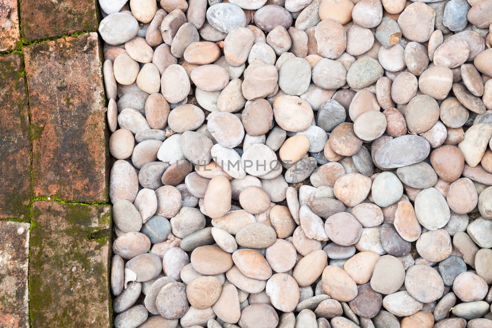 Pebble stones and bricks abstract background by punsayaporn