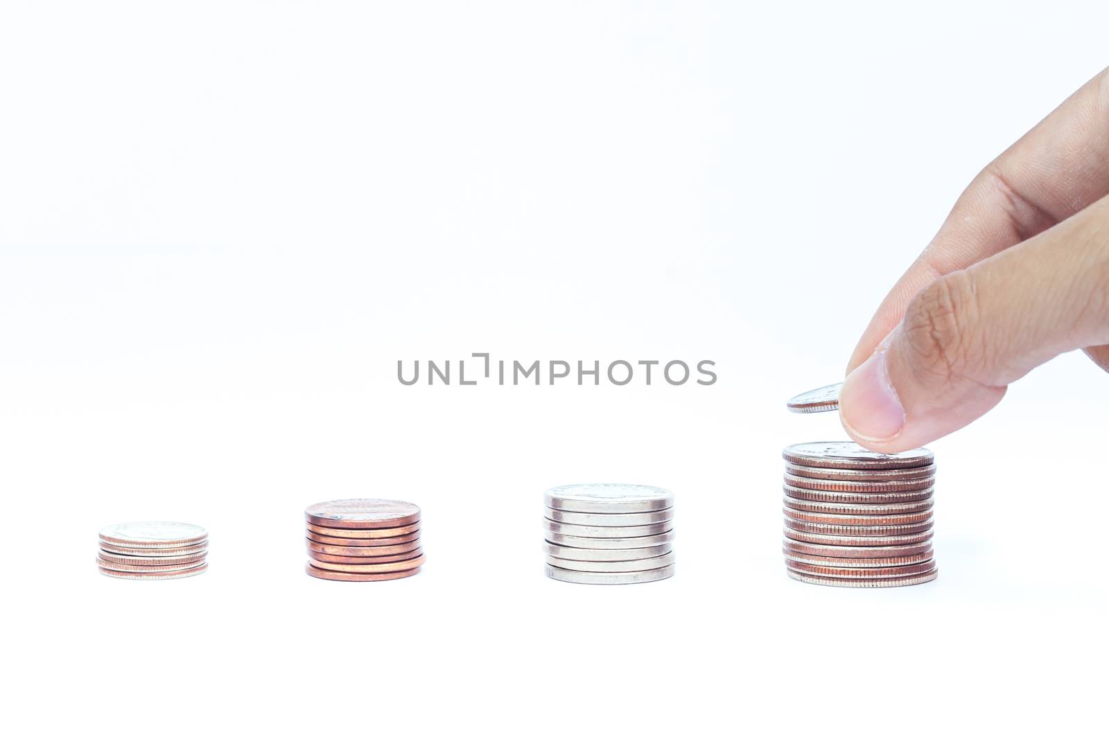 Woman hand putting money coin for saving money concept