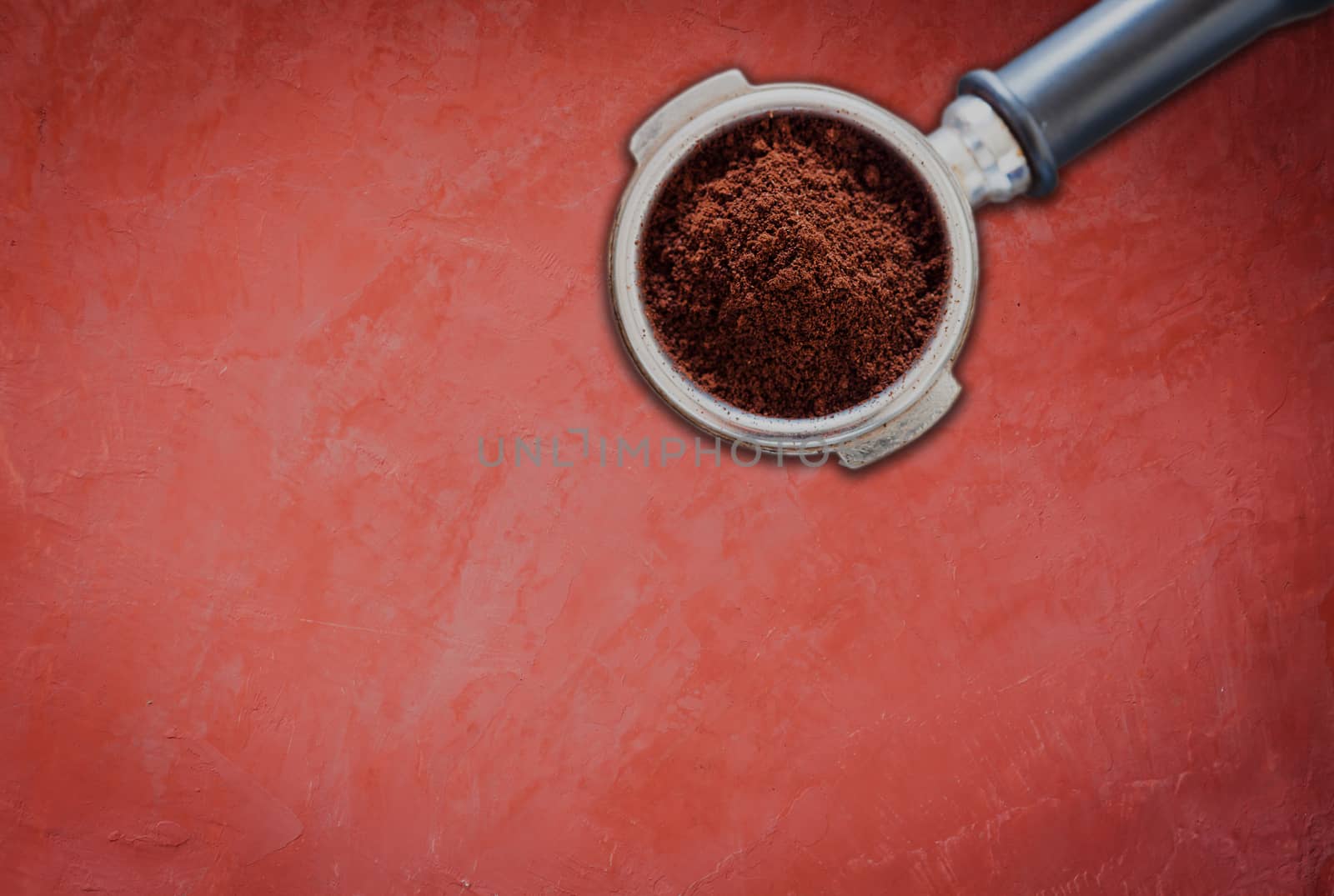 Coffee grind in group on red concrete background, stock photo