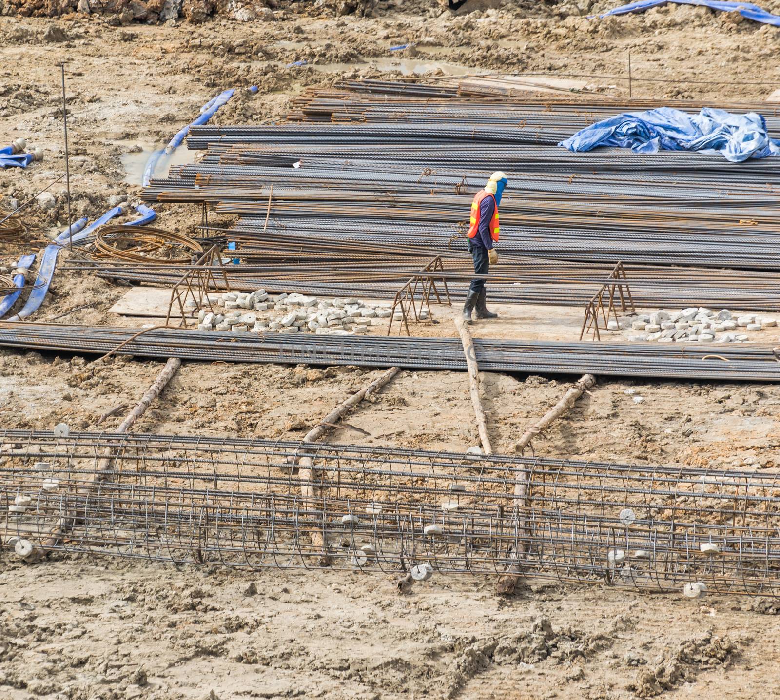 Construction workers are preparing pump for concrete for pouring.