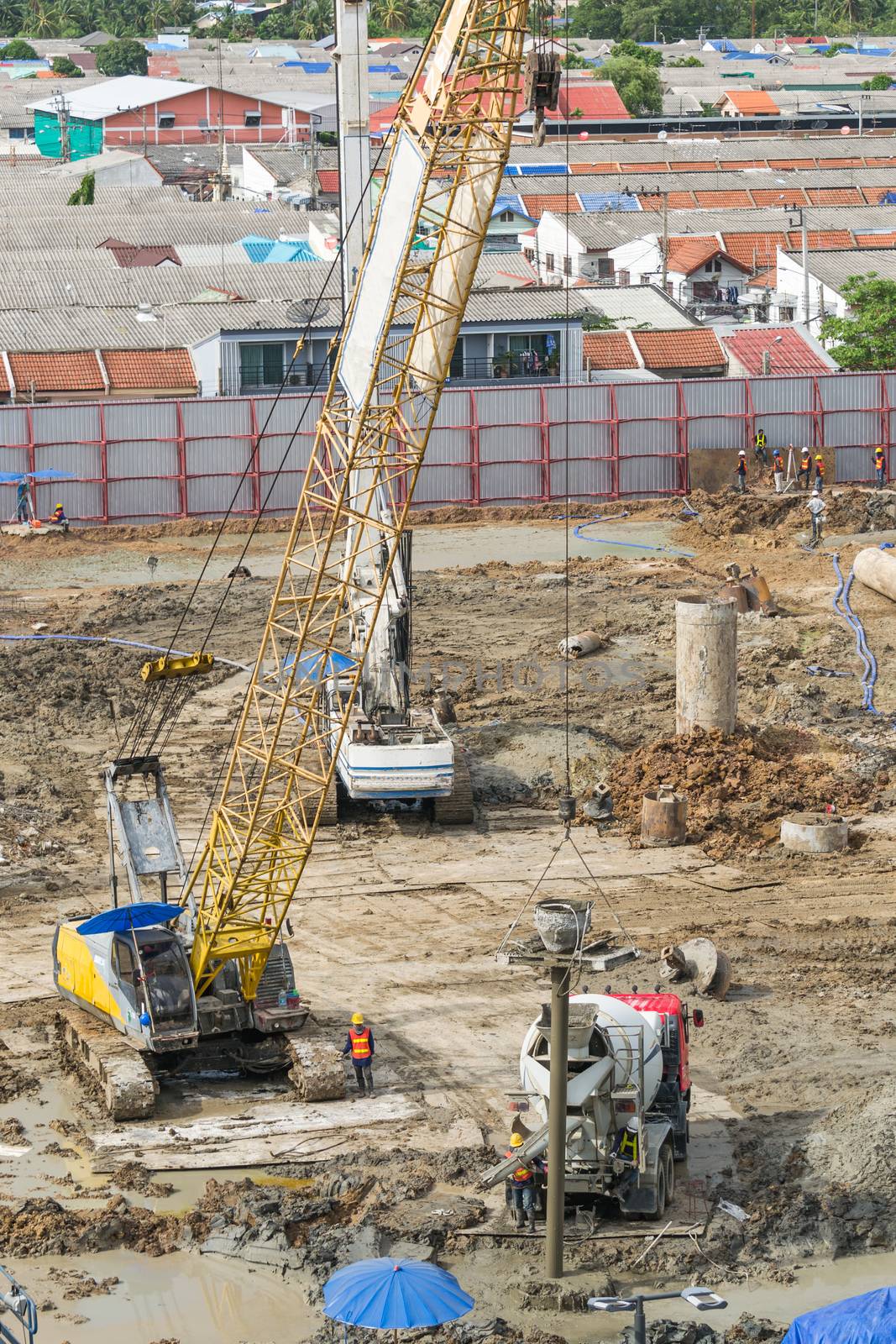 Construction workers are preparing pump for concrete for pouring.