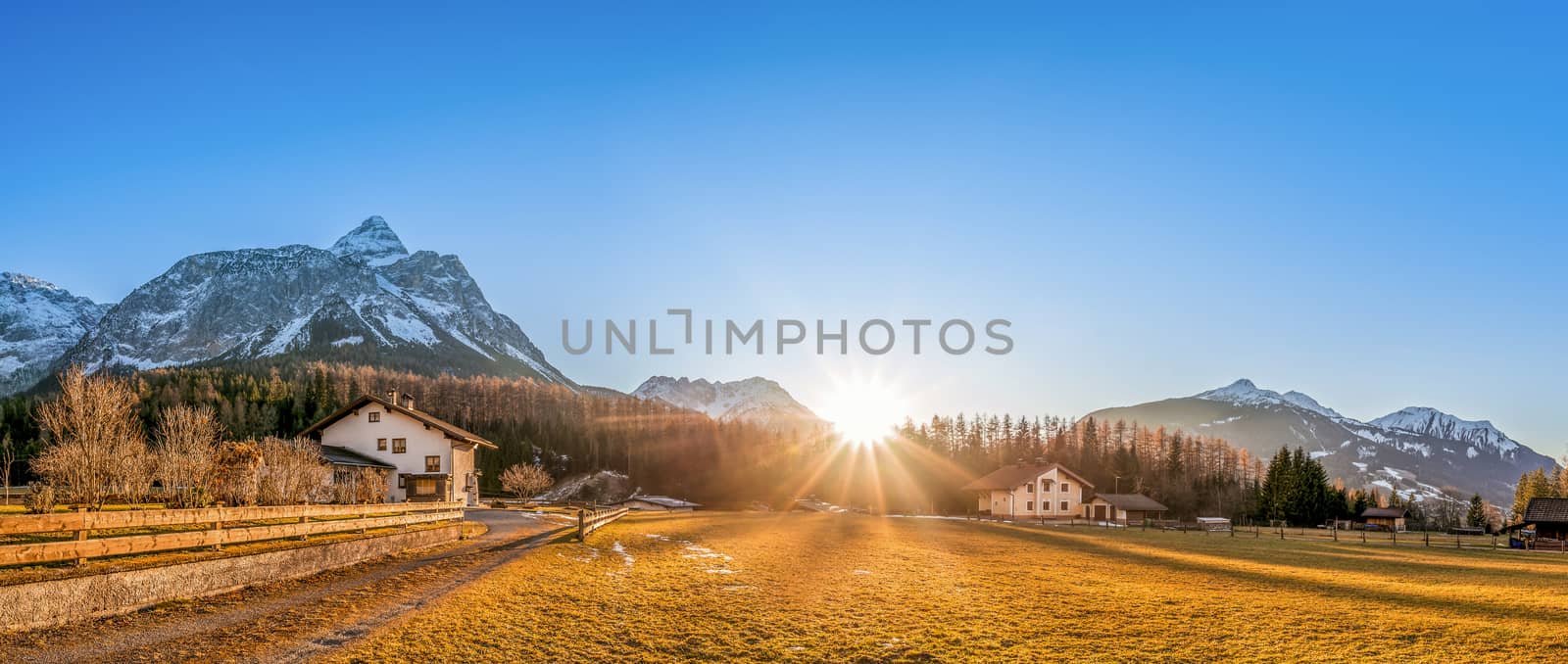 Beautiful mountain landscape with a small village, called Ehrwald, located at the foot of the Austrian Alps, under a clear blue sky and a gorgeous sun.