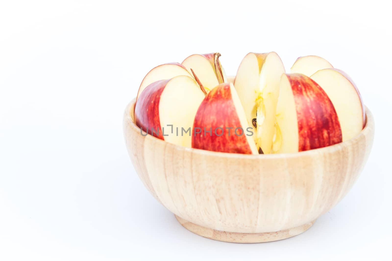 Sliced apple in wooden bowl by punsayaporn