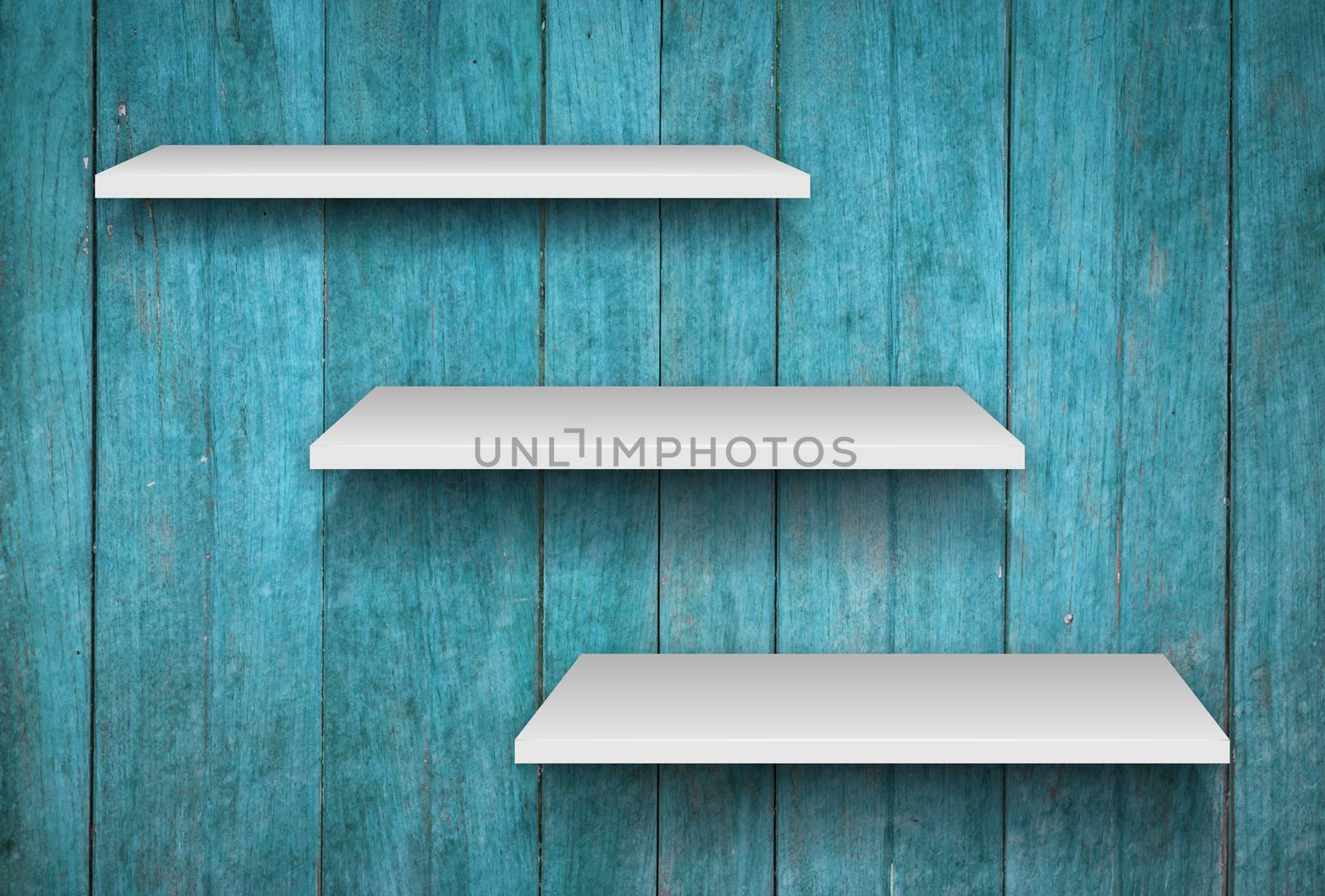 Three white shelves on blue wooden texture background by punsayaporn