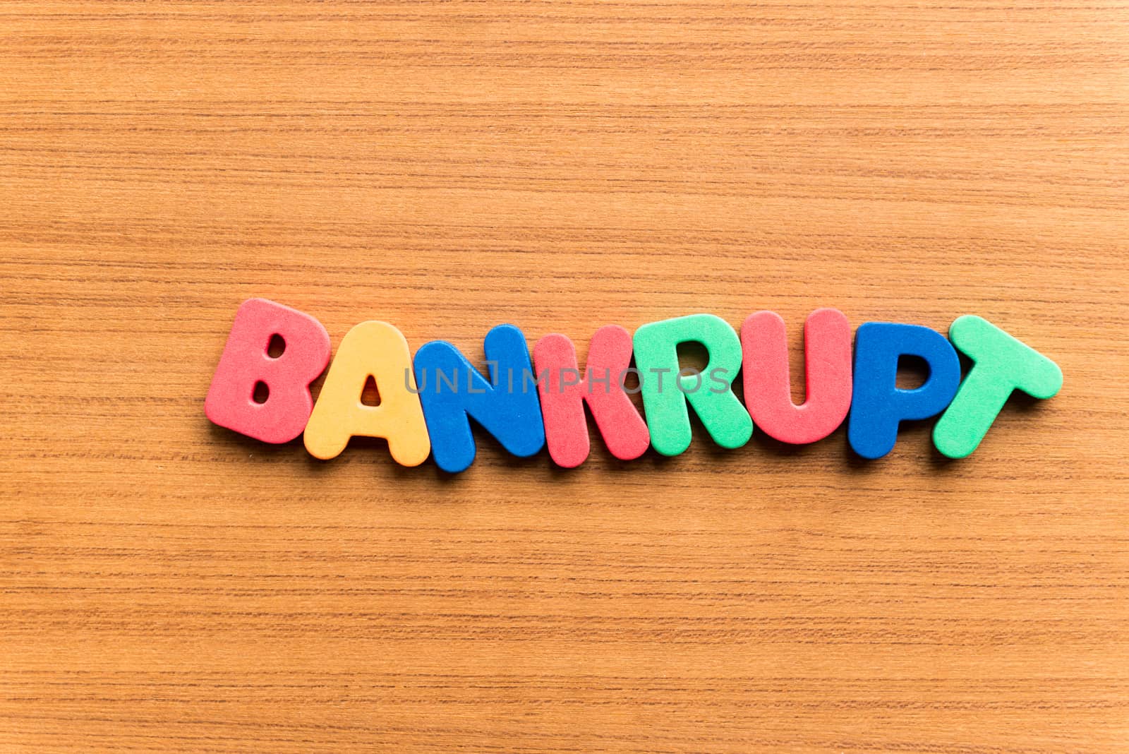 bankrupt colorful word on the wooden background