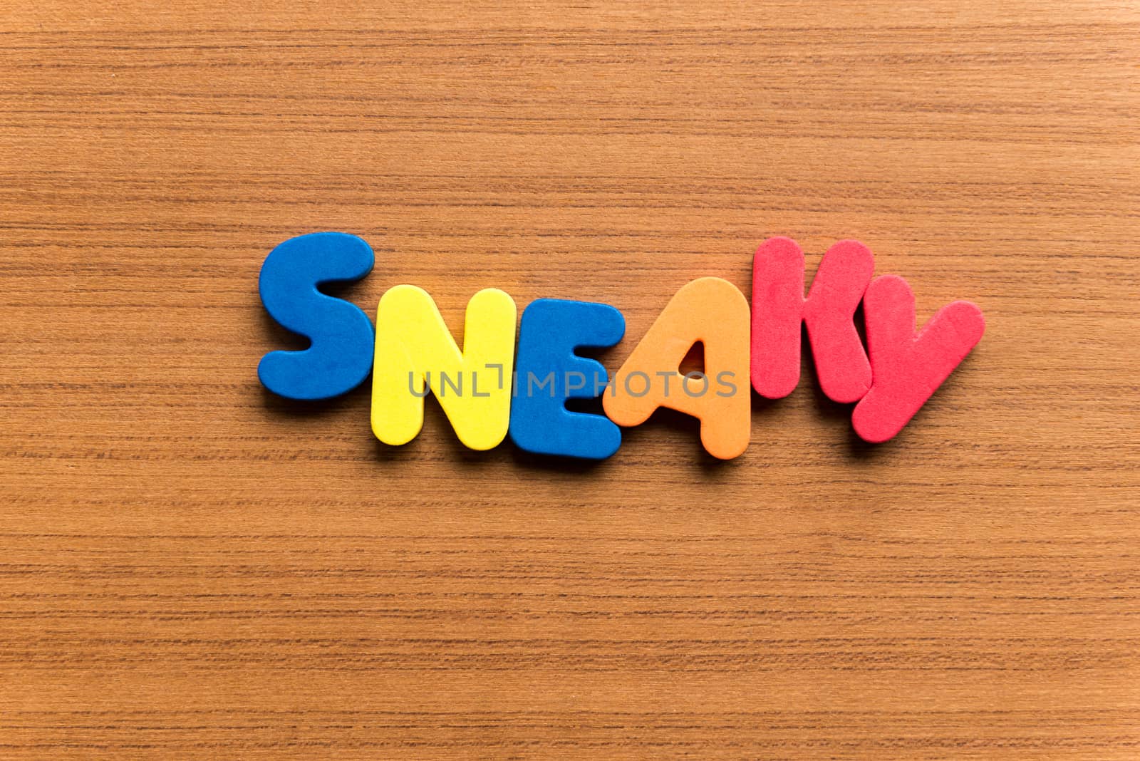 sneaky colorful word on the wooden background
