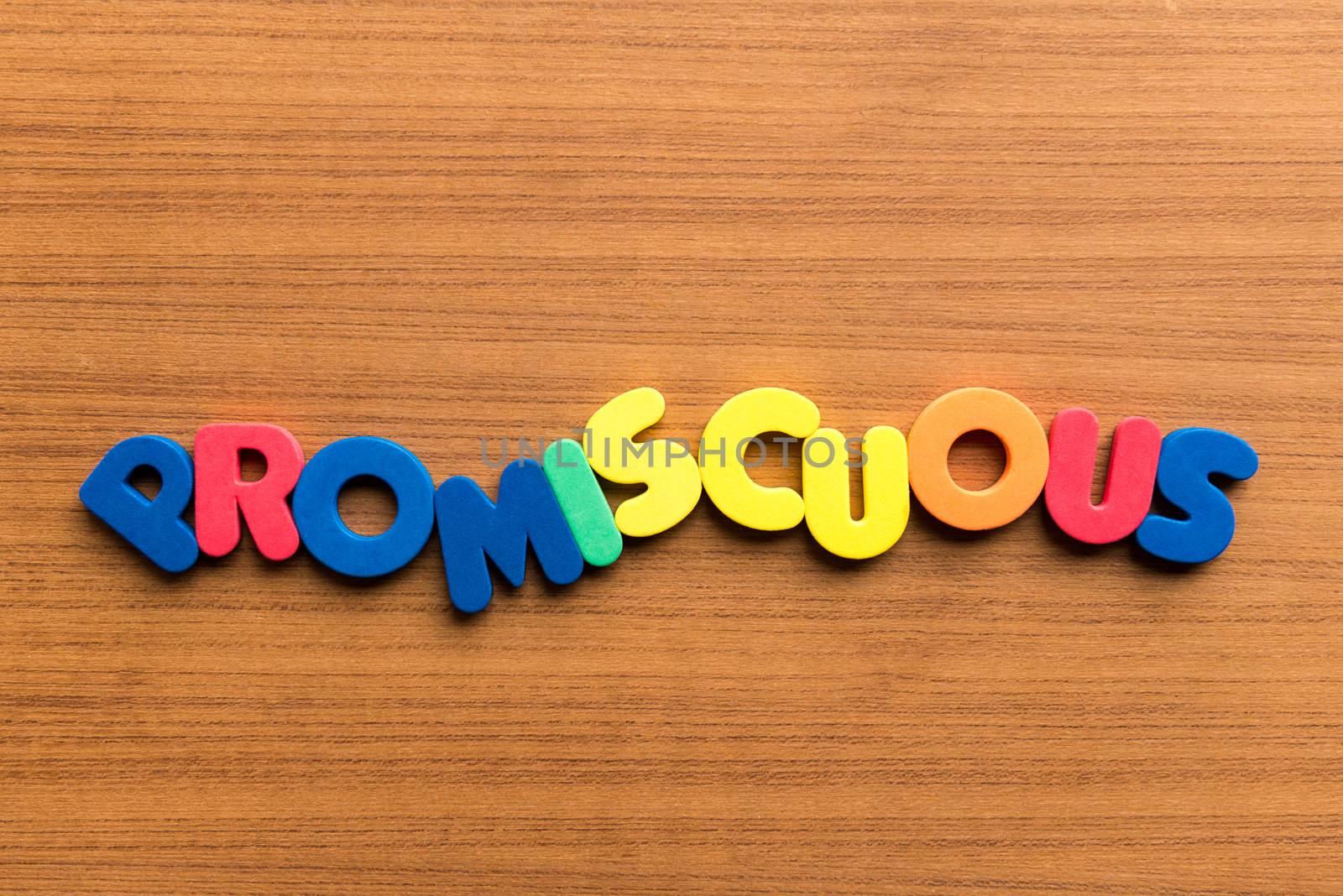 promiscuous colorful word on the wooden background