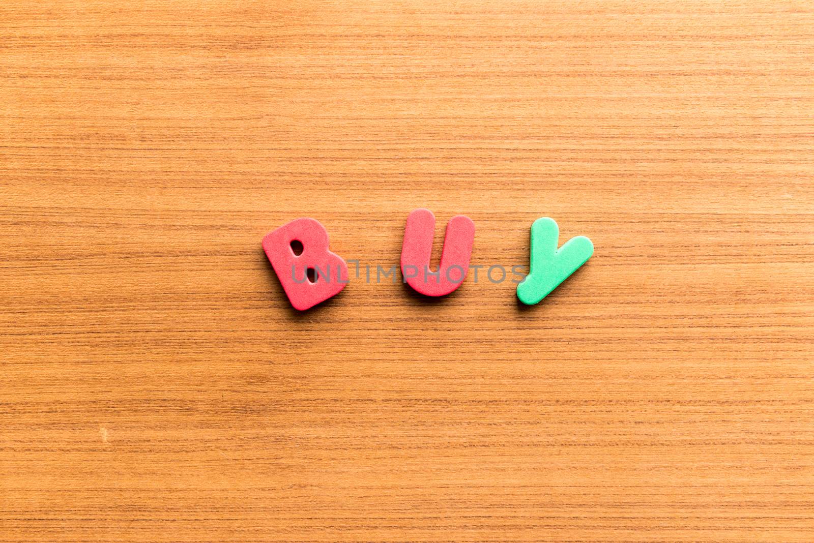 buy colorful word on the wooden background