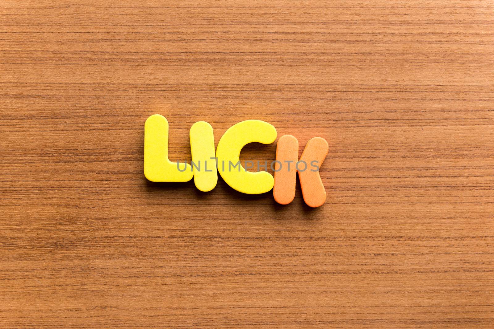 lick colorful word on the wooden background