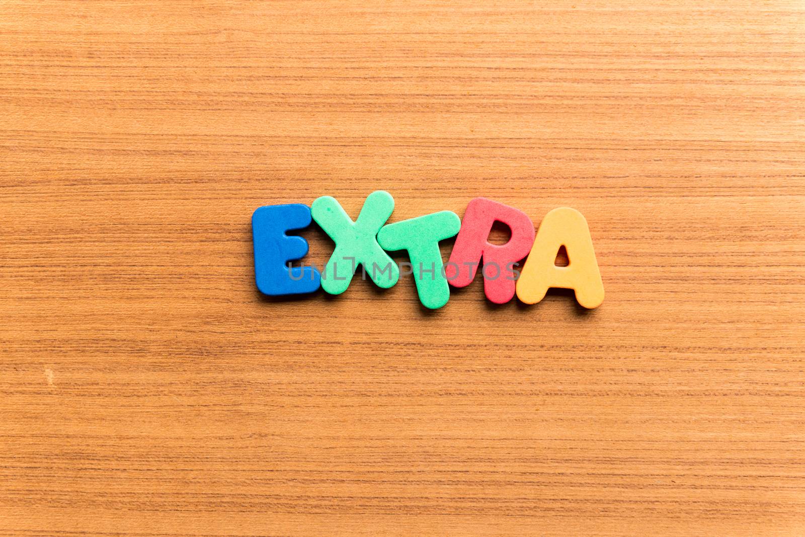 extra colorful word on the wooden background