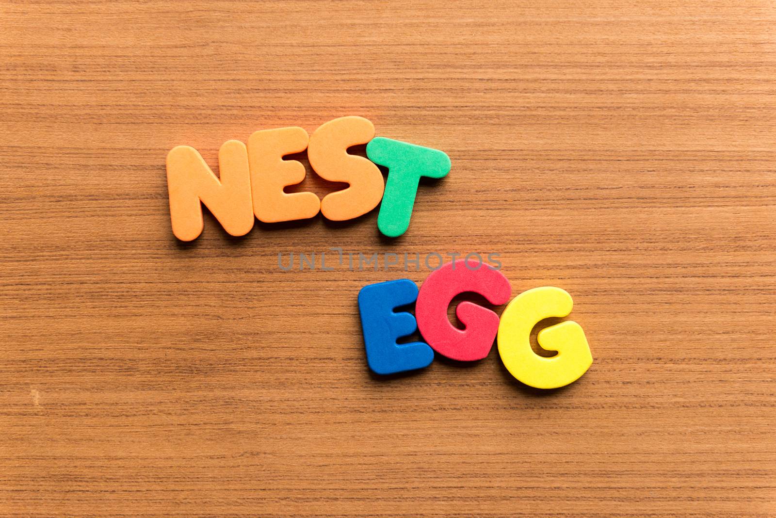 nest egg colorful word on the wooden background