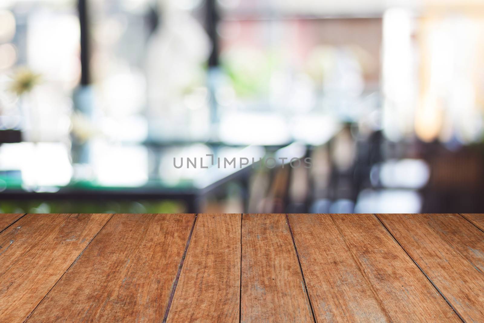 Empty wooden table and blurred cafe background, stock photo