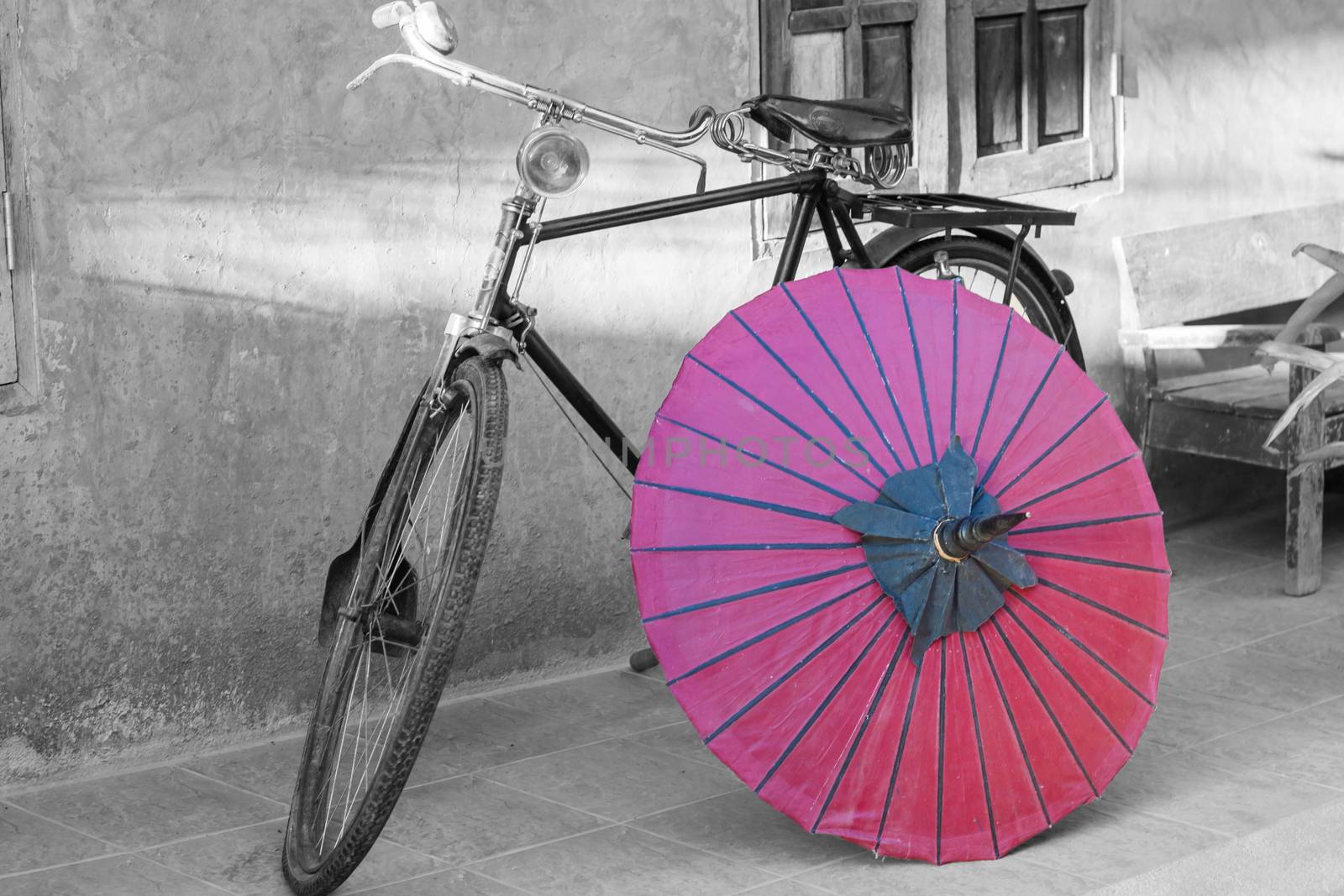 Retro bicycle with red umbrella with vintage filter by punsayaporn