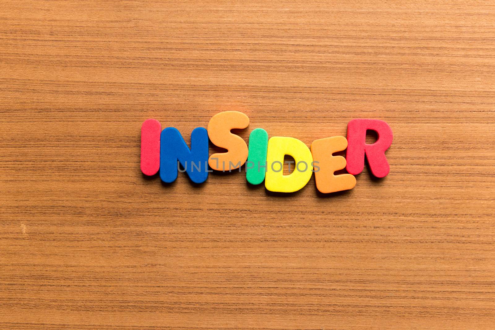 insider colorful word on the wooden background