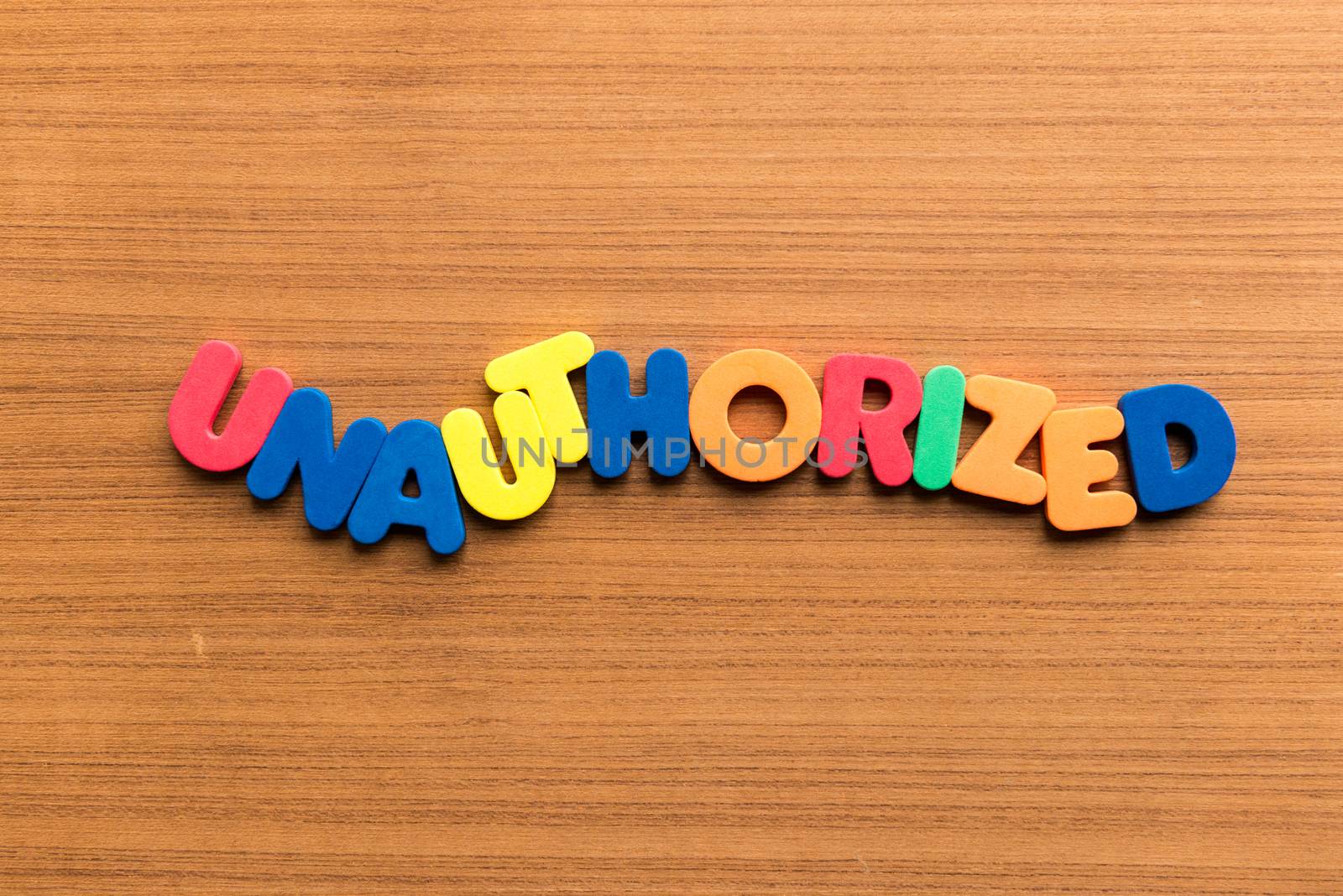 unauthorized colorful word on the wooden background