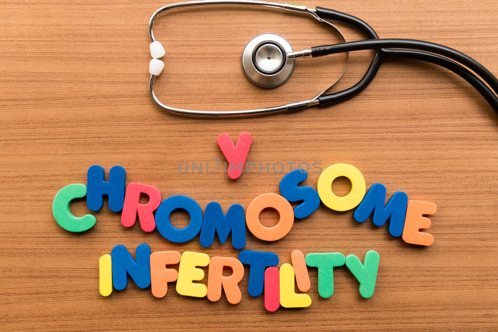 Y chromosome infertility colorful word with stethoscope on wooden background