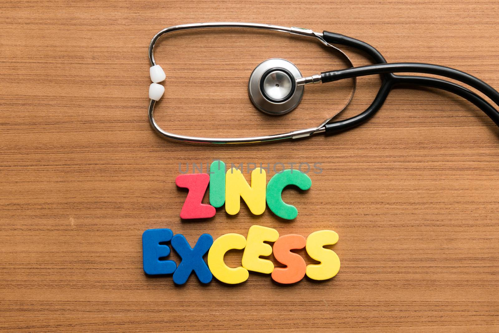 zinc excess colorful word with stethoscope on wooden background