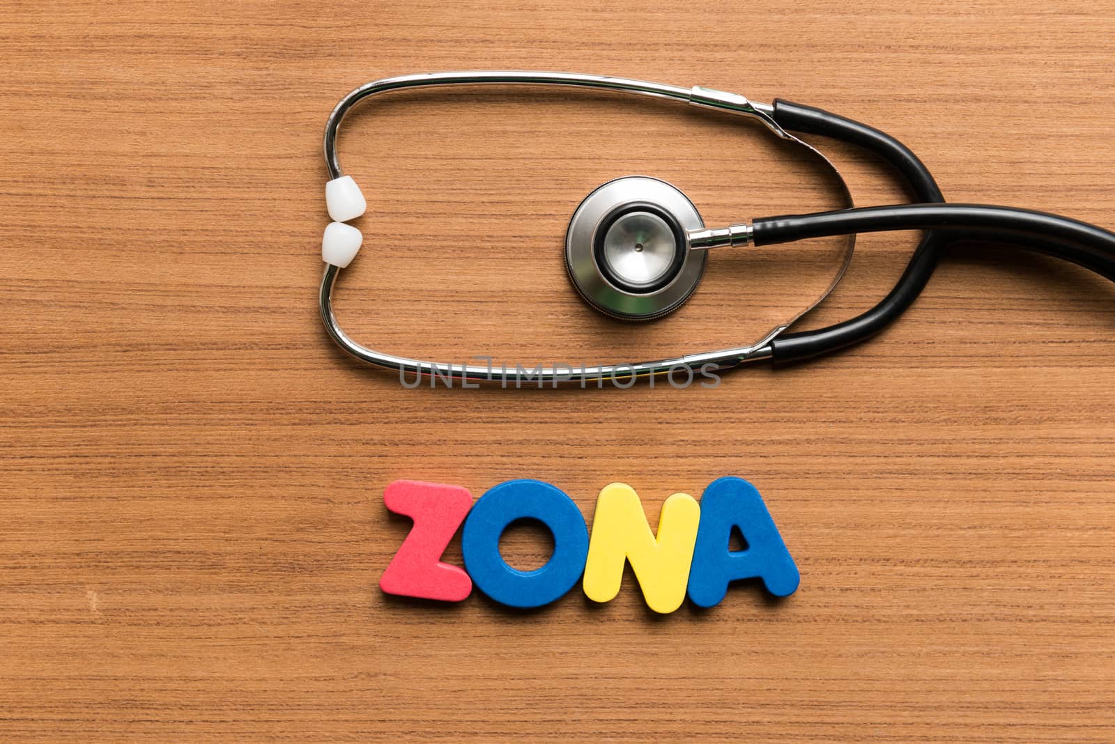zona colorful word with stethoscope on wooden background