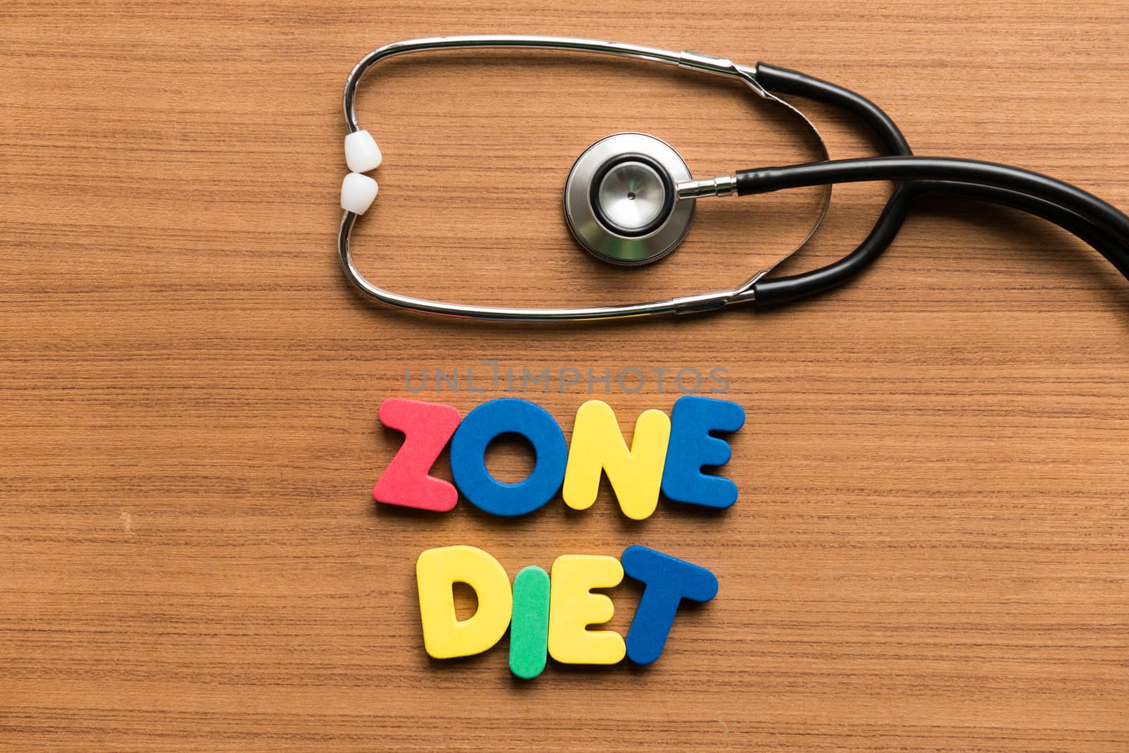 zone diet colorful word with stethoscope on wooden background