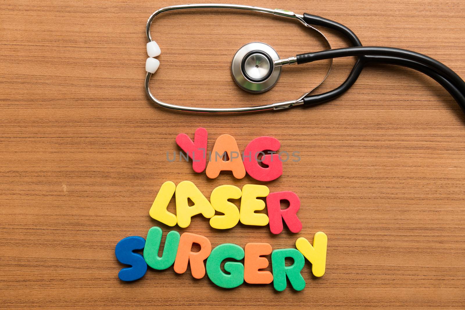 yag laser surgery colorful word with stethoscope on wooden background