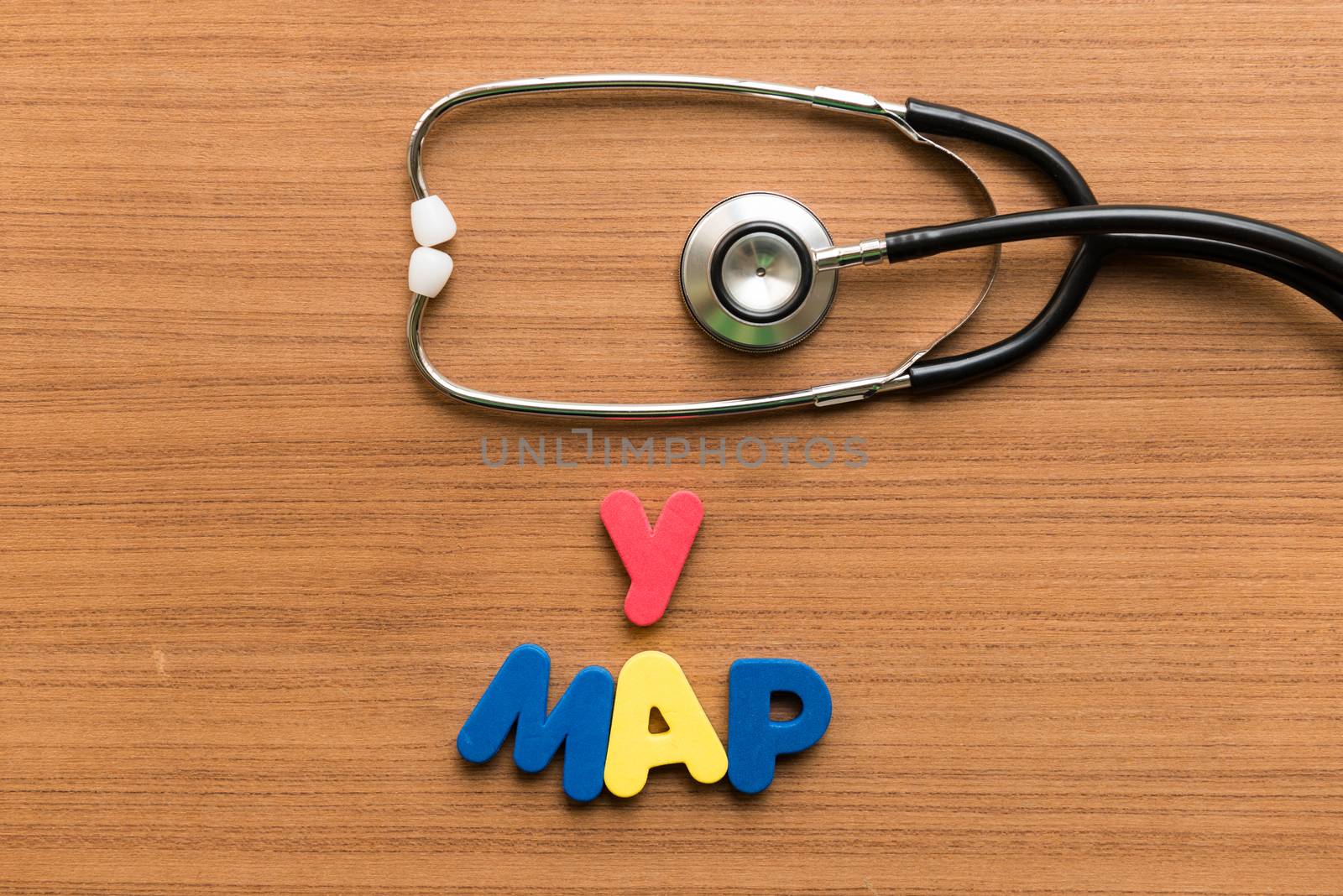 y map colorful word with stethoscope on wooden background