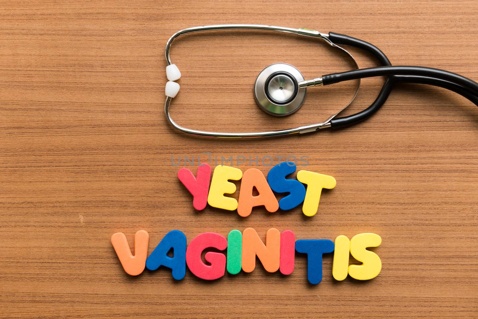 yeast vaginitis colorful word with stethoscope on wooden background