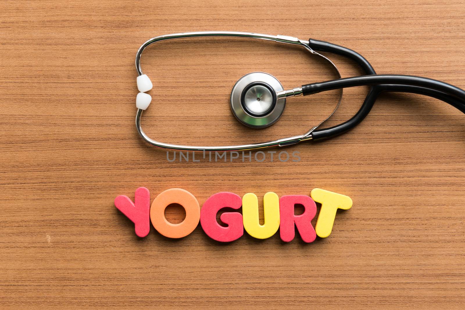 yogurt colorful word with stethoscope on wooden background