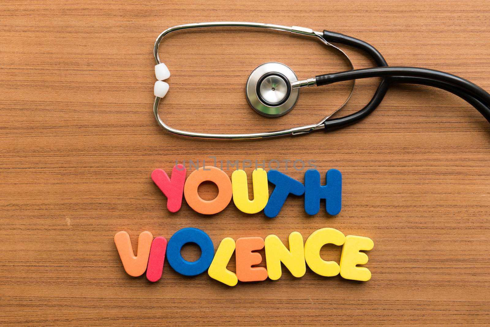 youth violence colorful word with stethoscope on wooden background