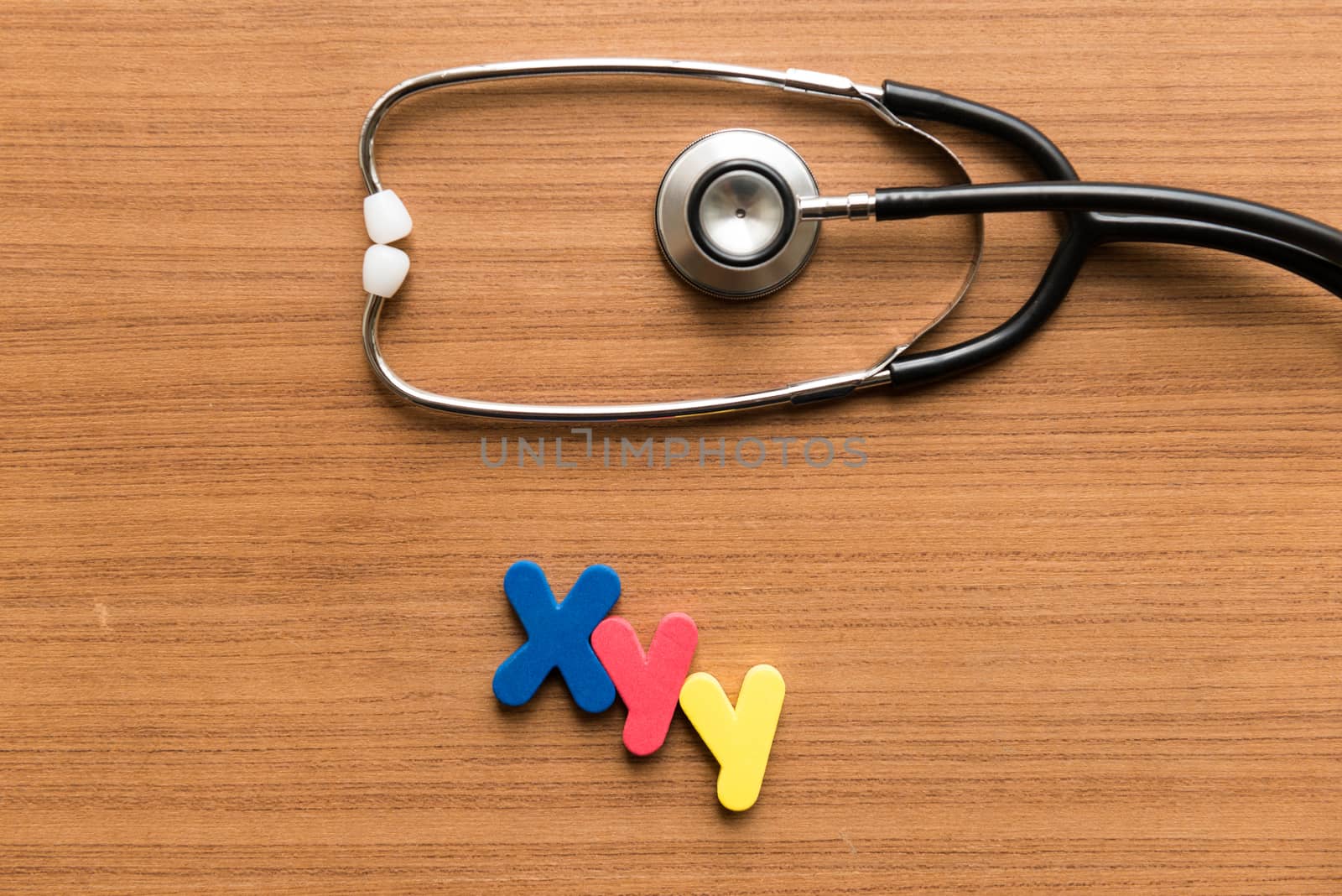 xyy colorful word with stethoscope on wooden background