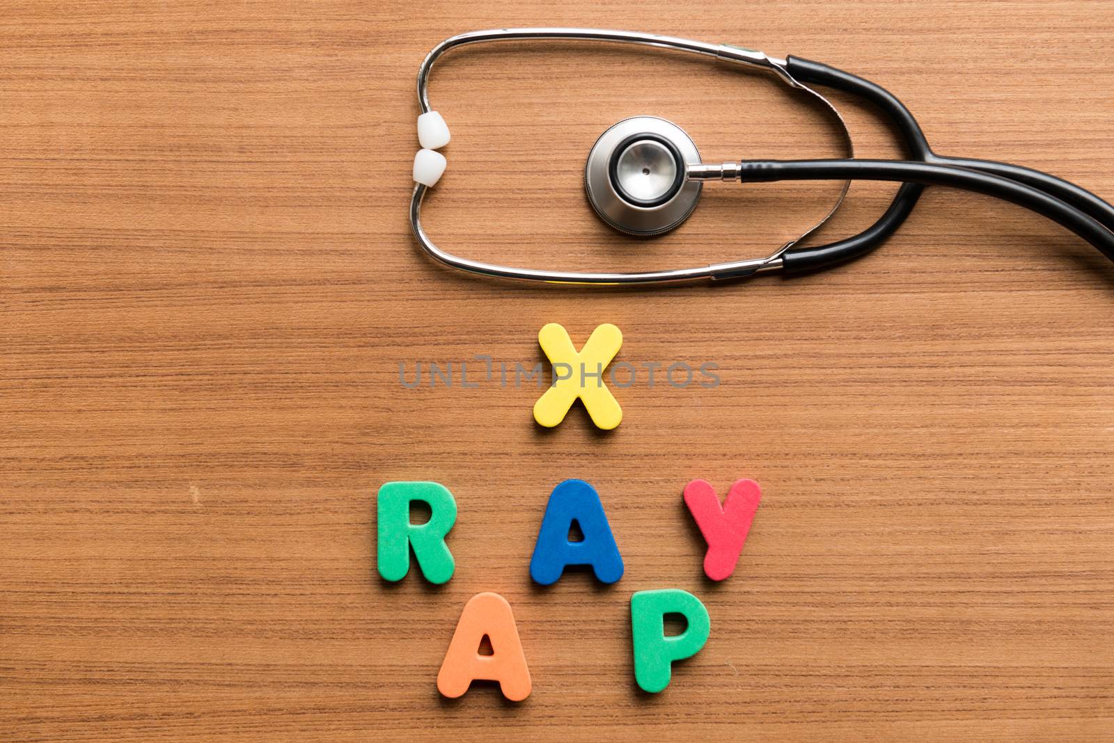 x ray ap colorful word with stethoscope on wooden background