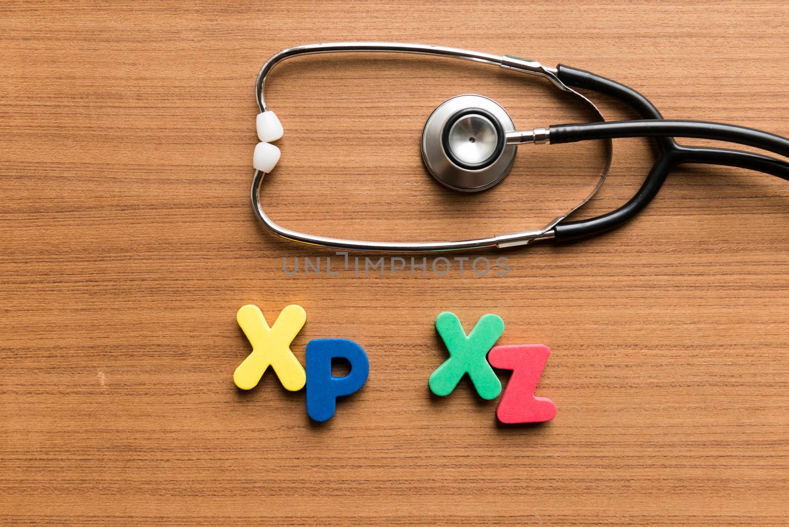 xp xz colorful word with stethoscope on wooden background
