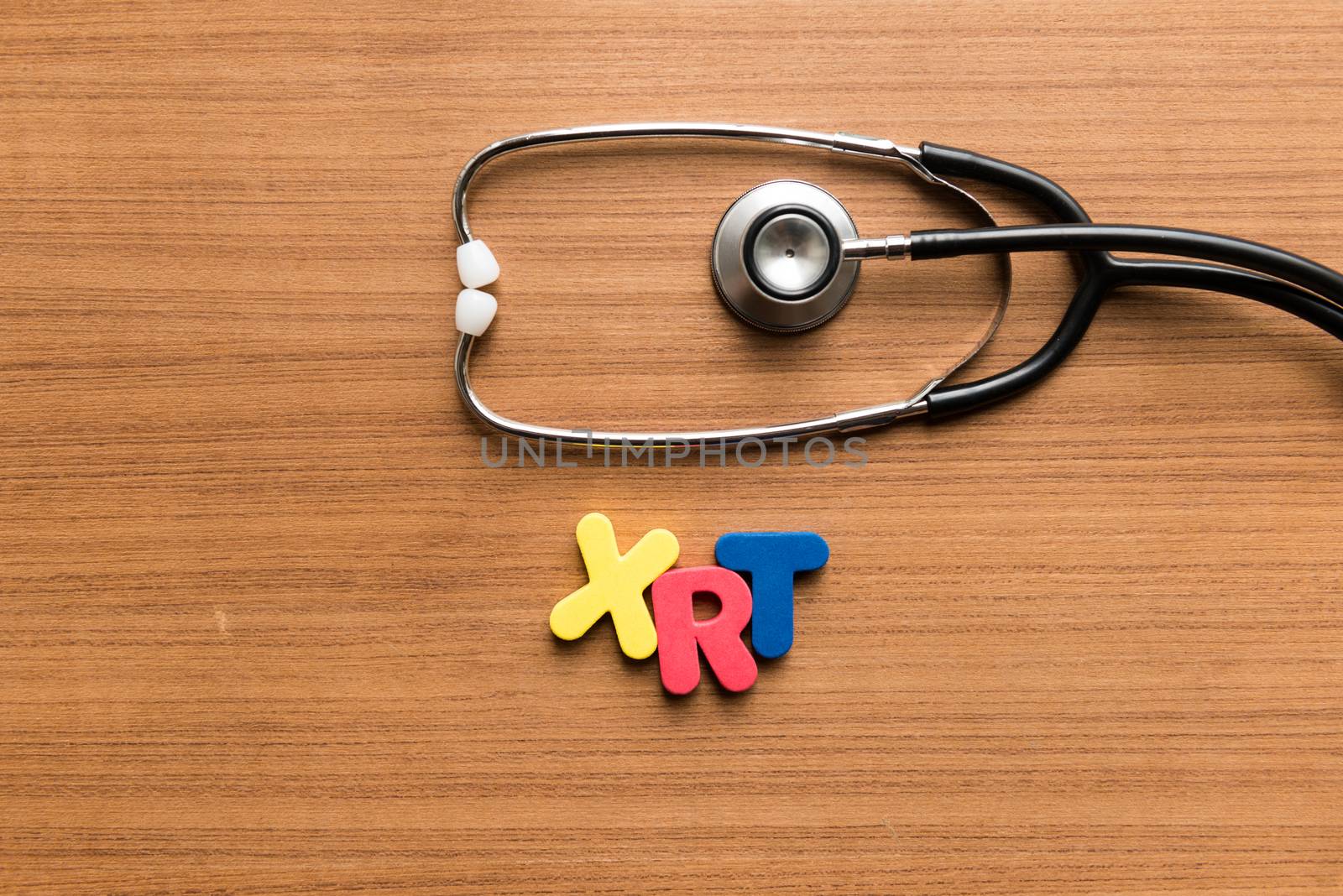 xrt colorful word with stethoscope on wooden background