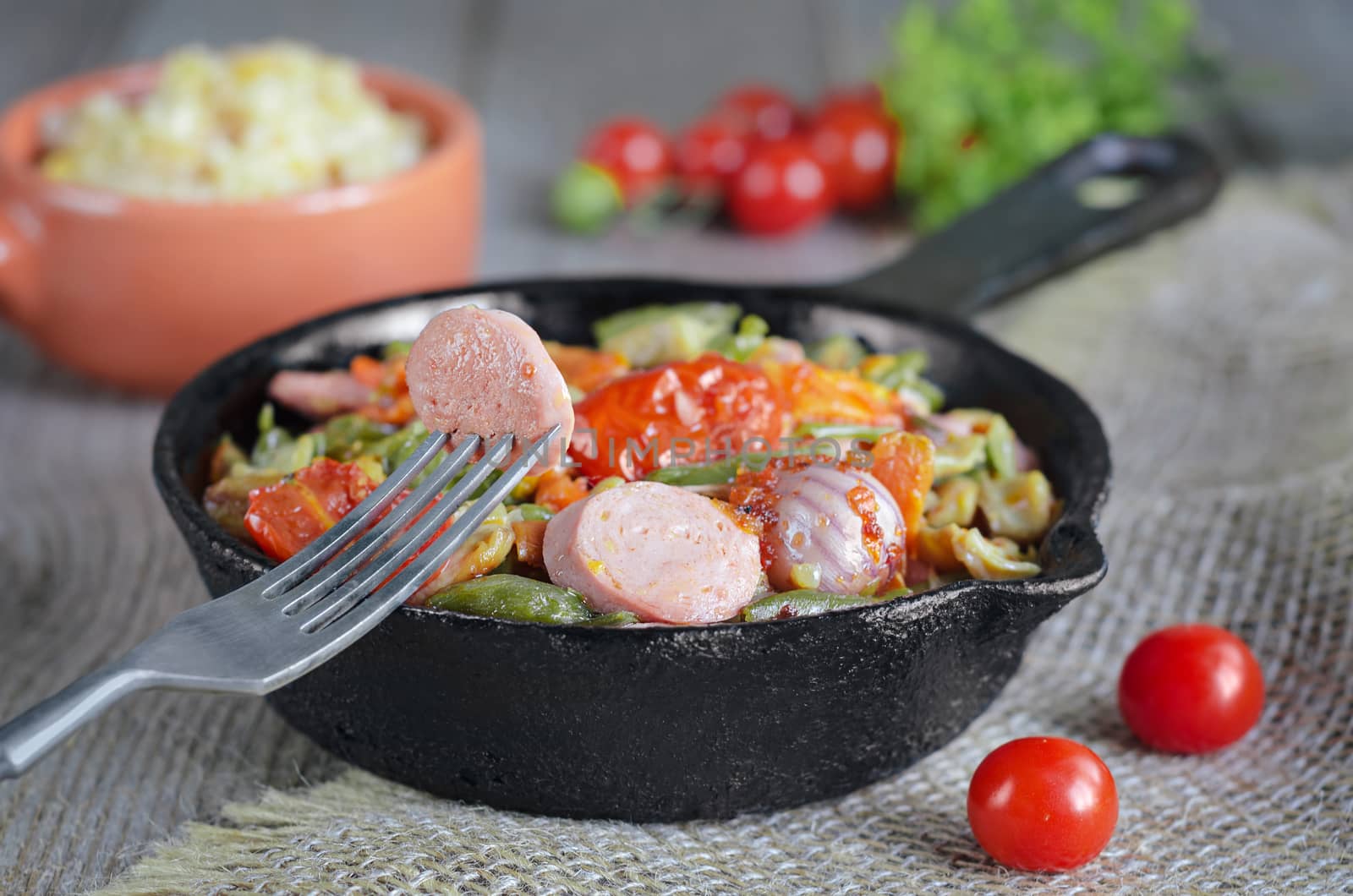 Vegetables with chopped sausages, fried in a pan. The rice and greens by Gaina