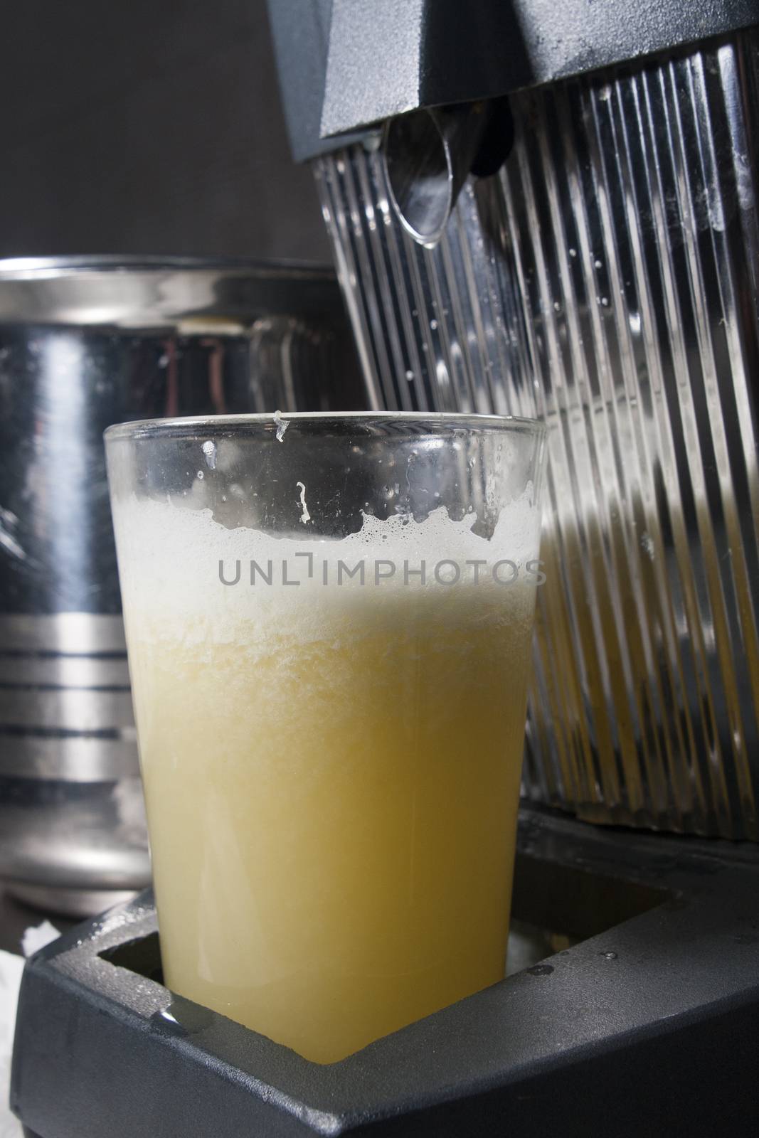 glass of fresh juice in juicer squeezer