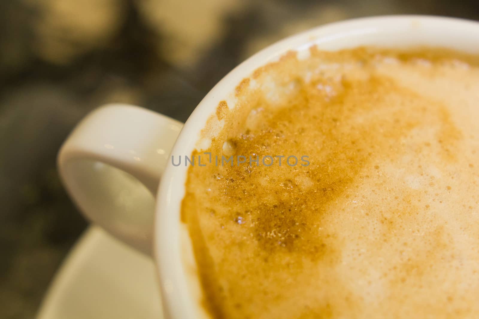 white ceramic cup with hot coffee  close up blurred