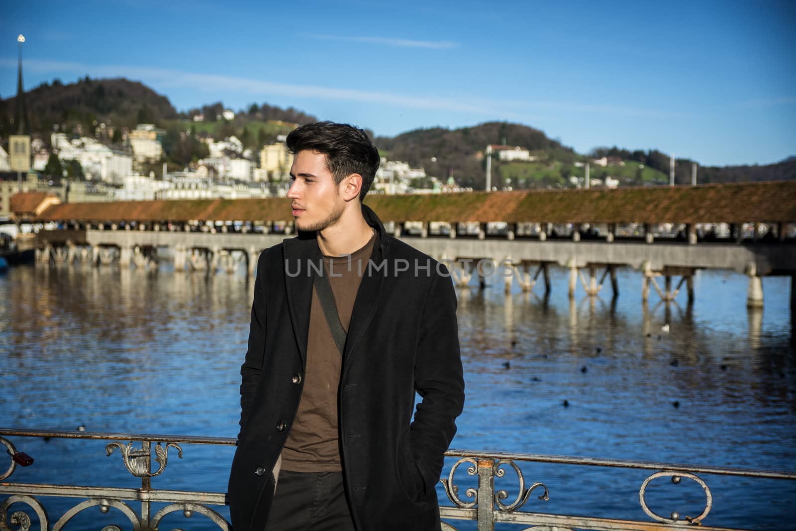 Man standing near metal fence in Lausanne by artofphoto