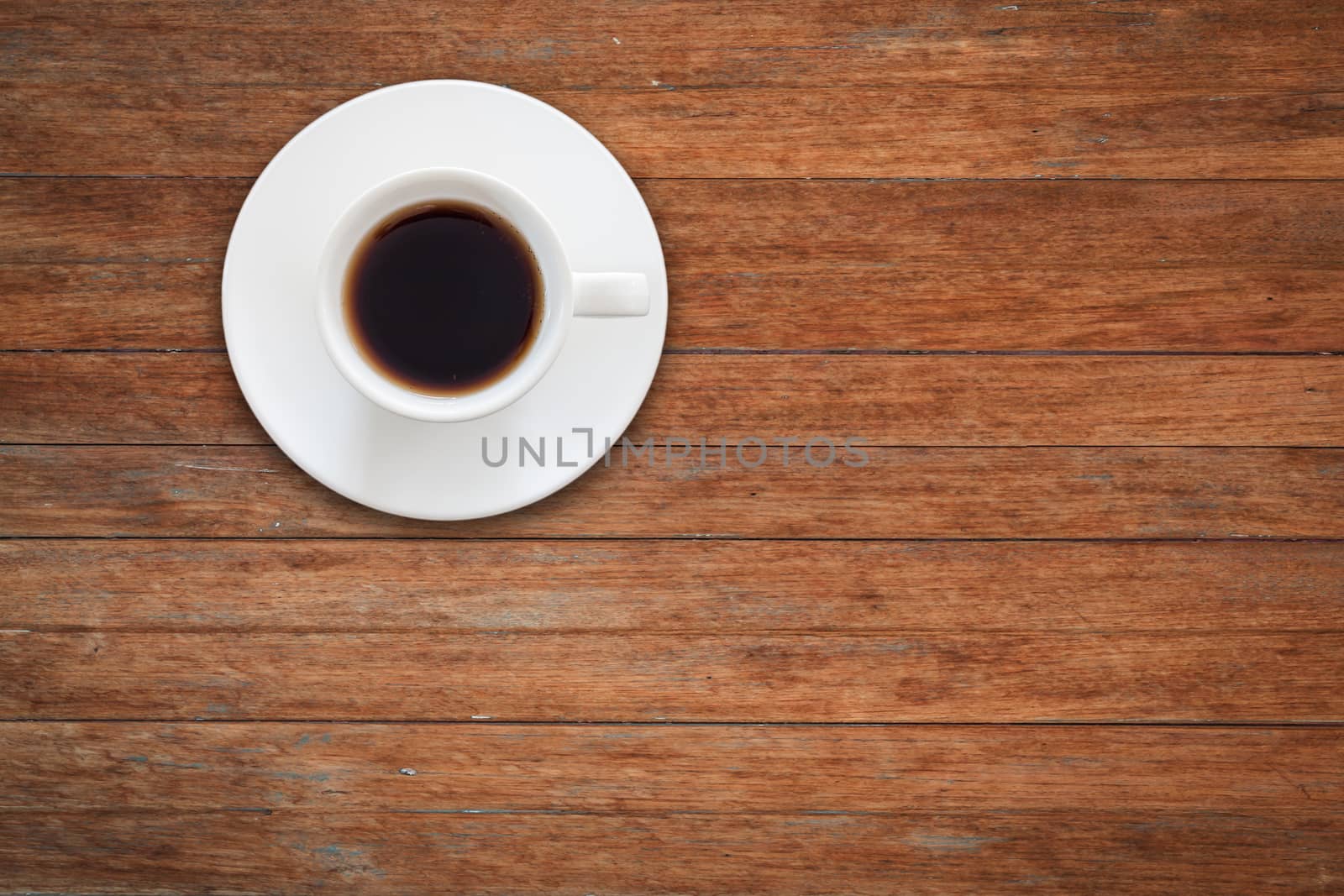 Close up white coffee cup on wooden table by punsayaporn