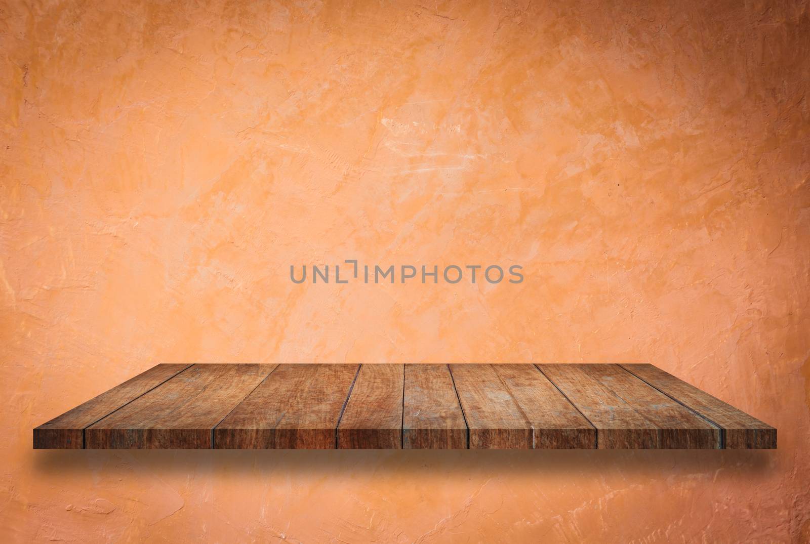 Empty perspective top wooden shelf on orange wall background