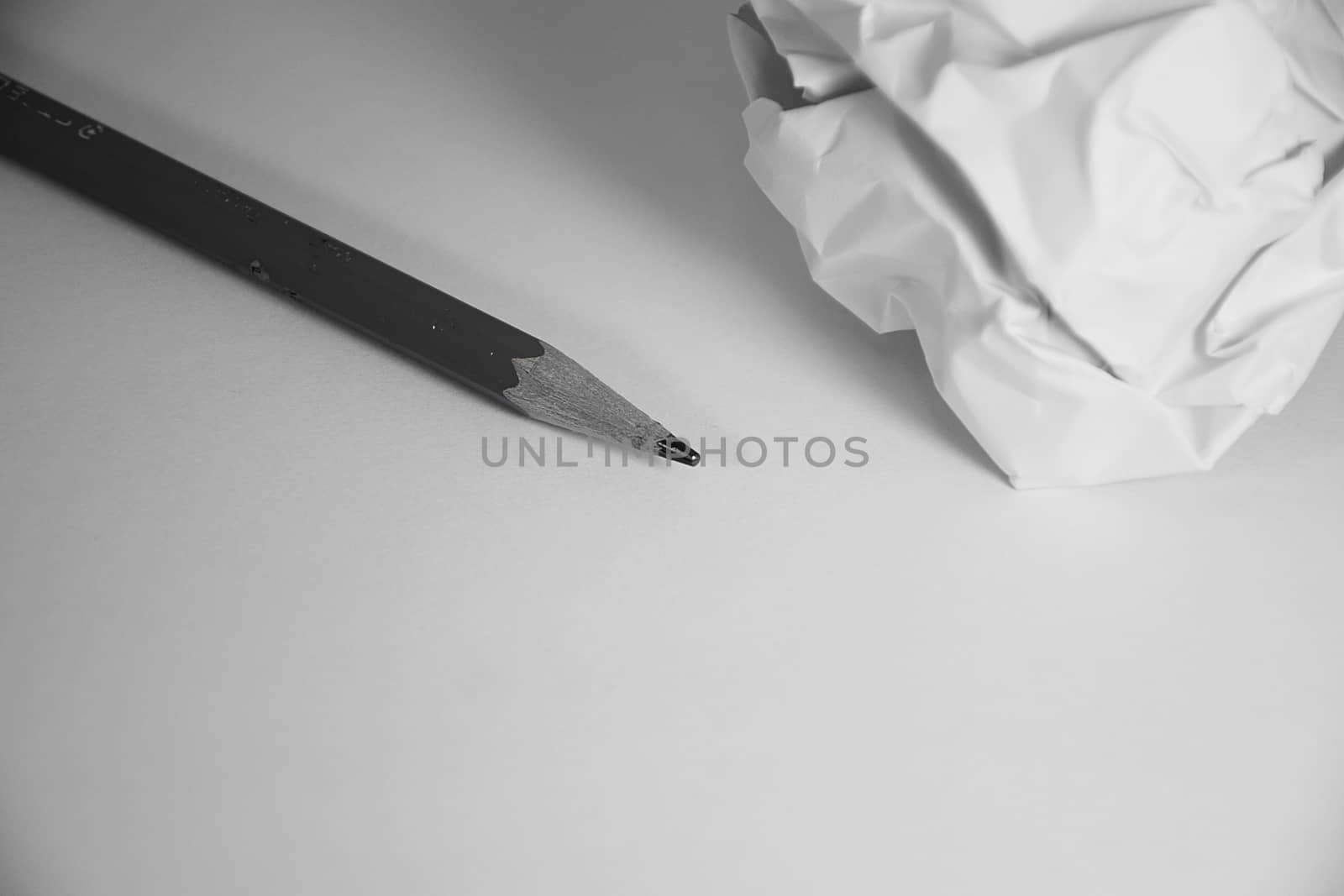 Wood pencil and crumpled Paper on white background.