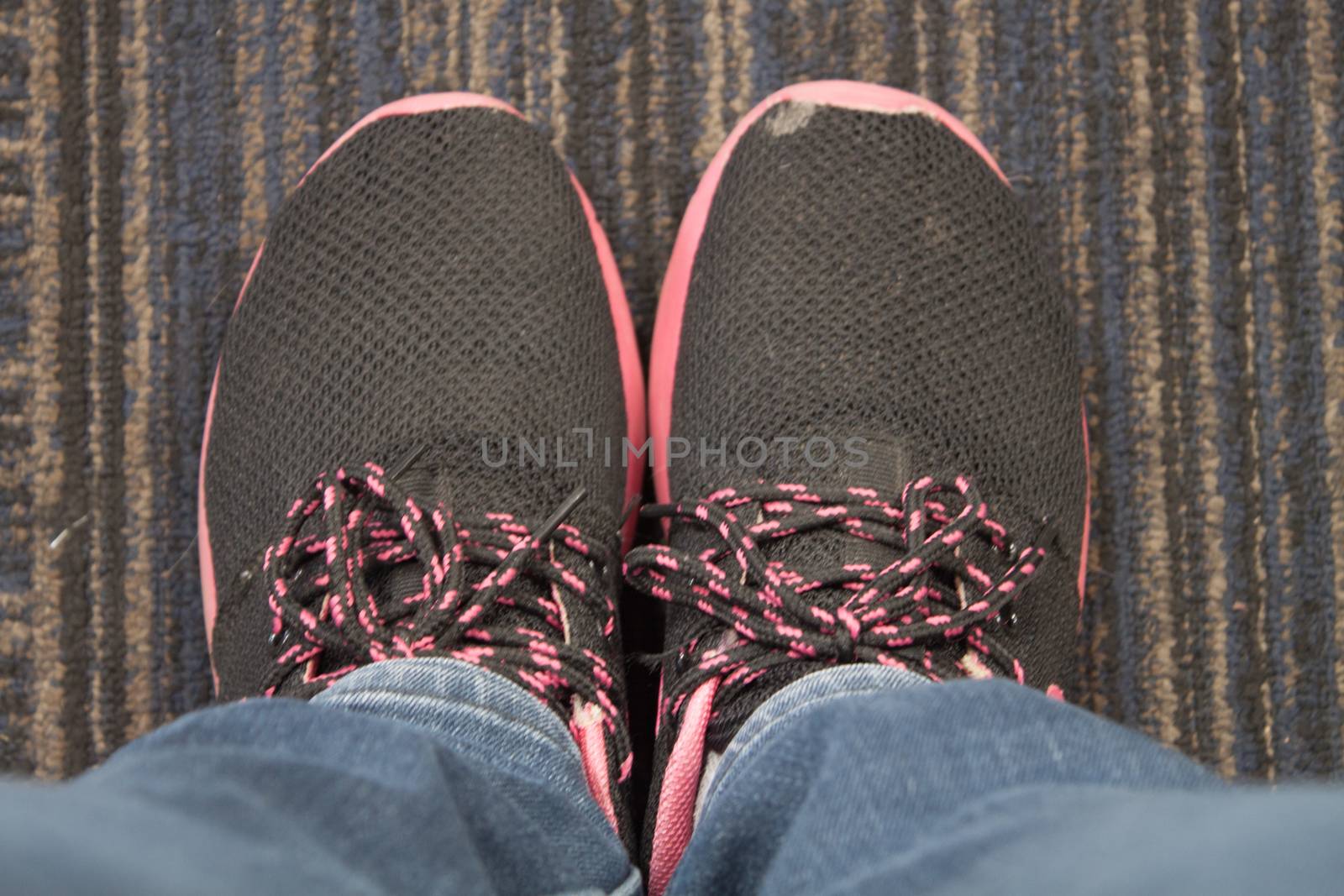 Top view of black shoe on carpet by punsayaporn