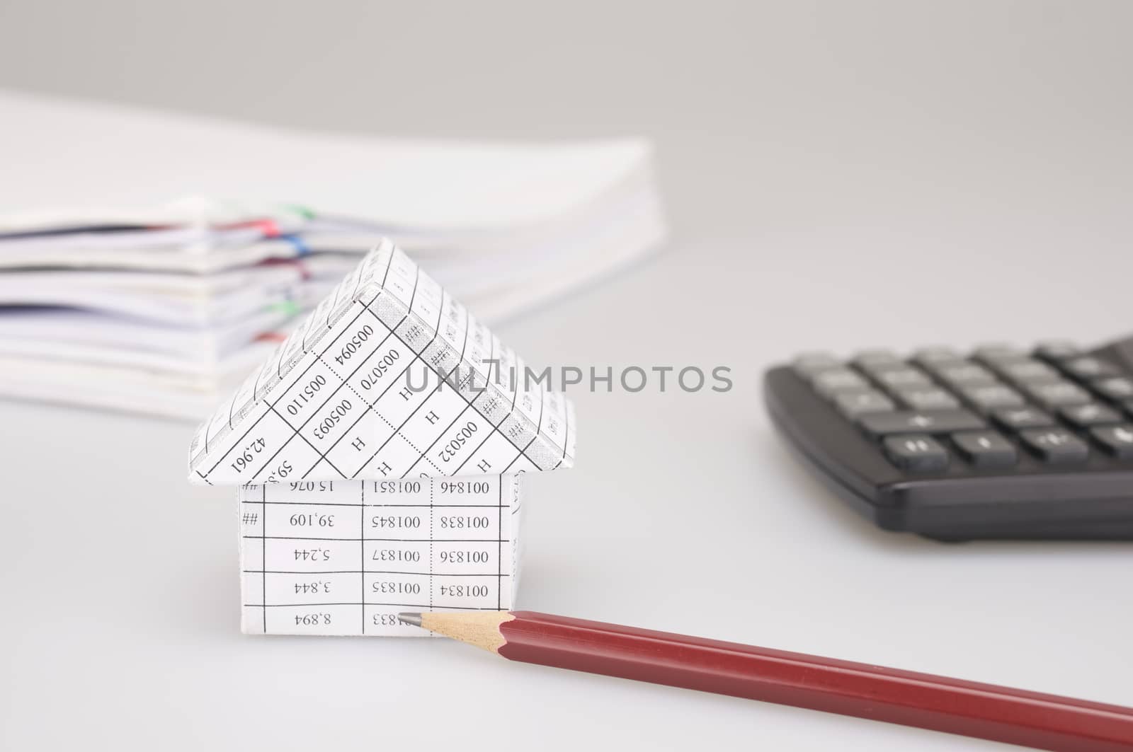 House and brown pencil have blur black calculator white background by eaglesky