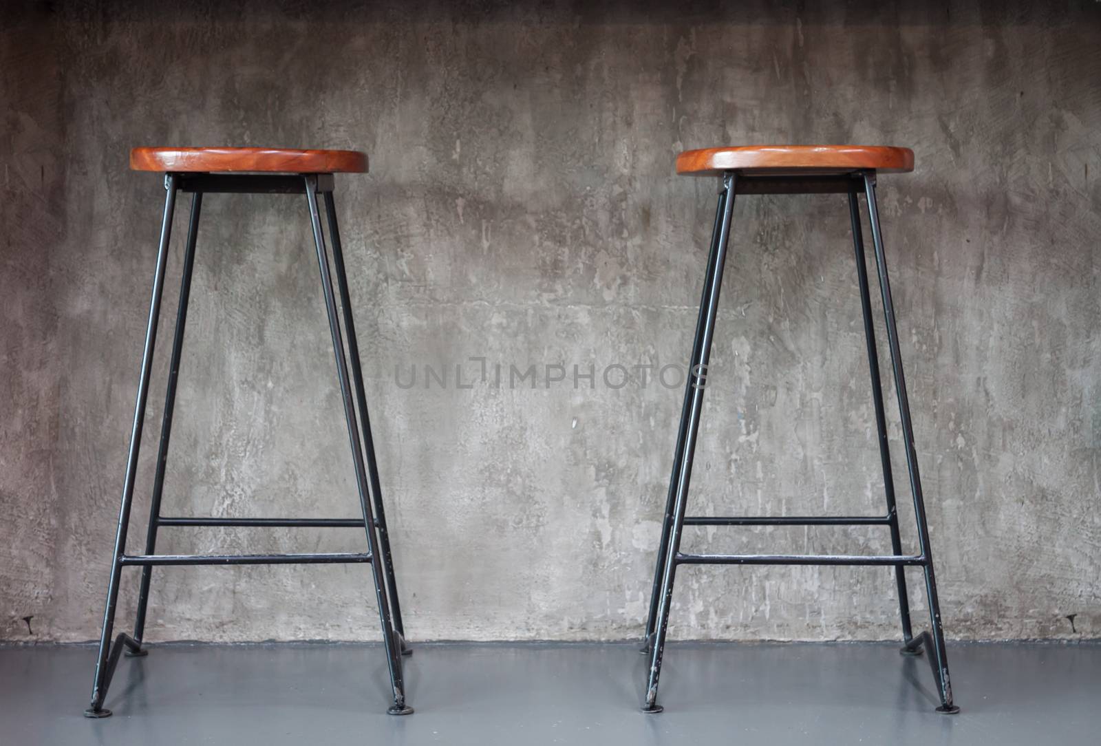 Elegant chairs with empty concrete background by punsayaporn