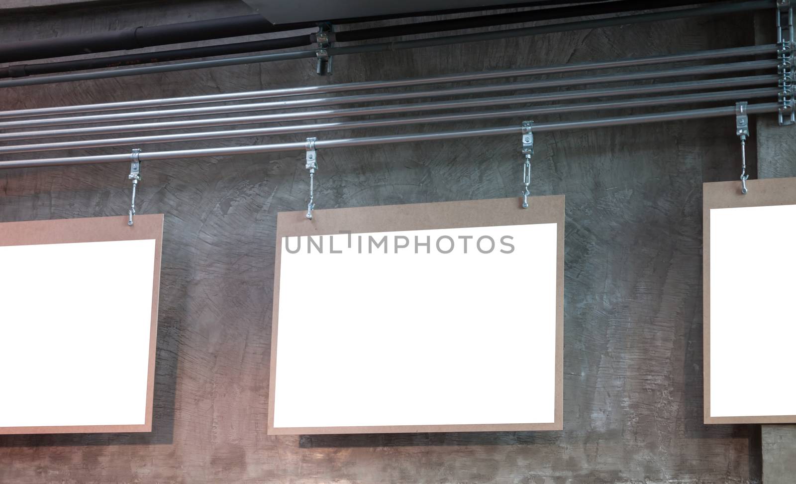 Hanging blank board with grey background, stock photo