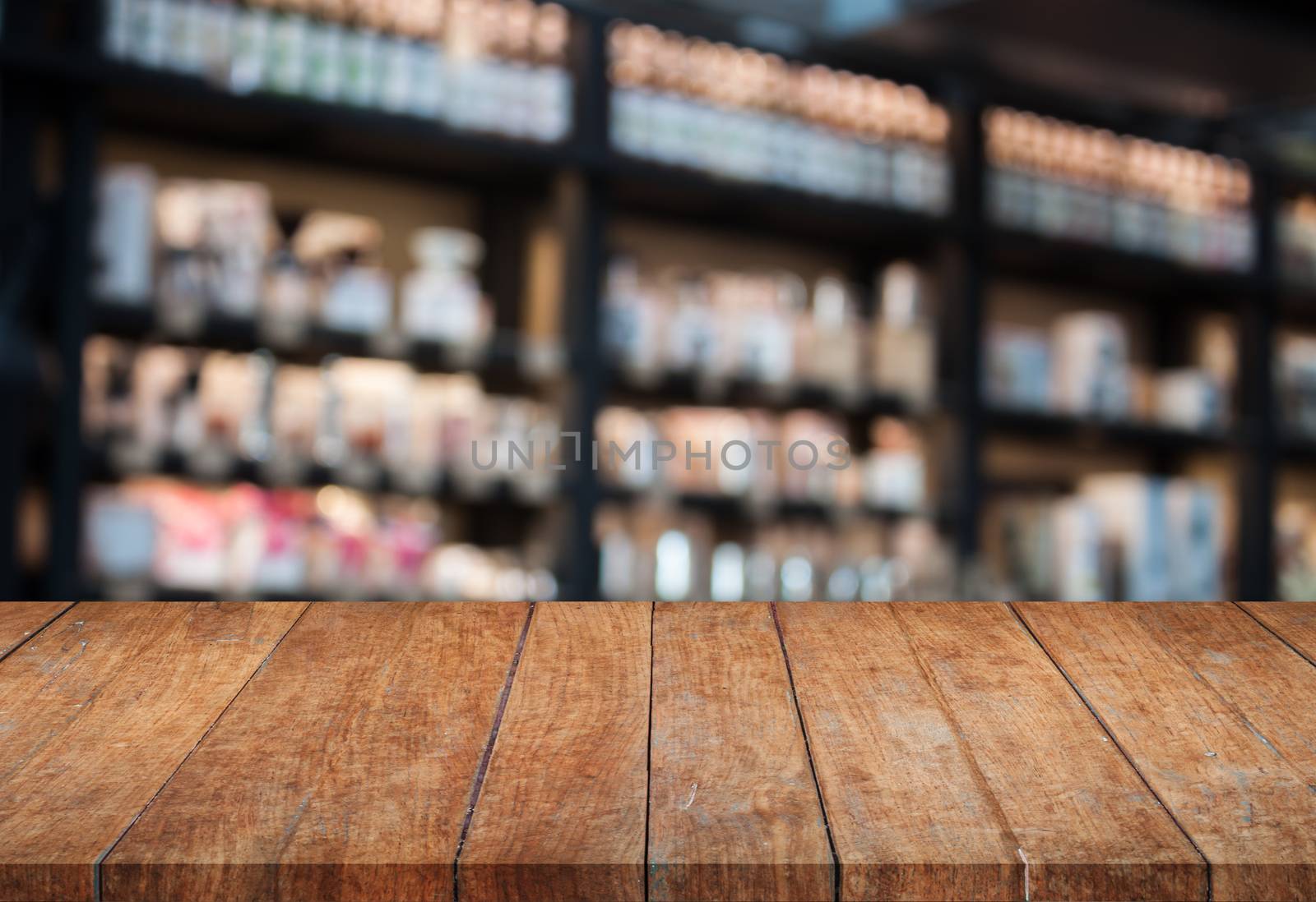 Perspective top wooden table with blurred cafe background by punsayaporn