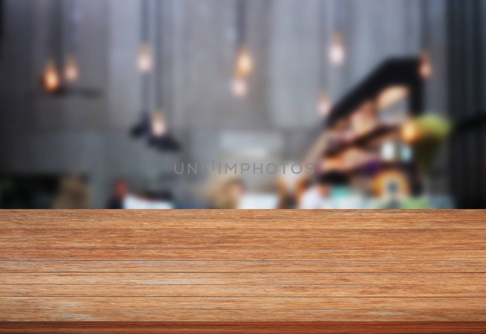 Top wooden table with blurred cafe background, stock photo