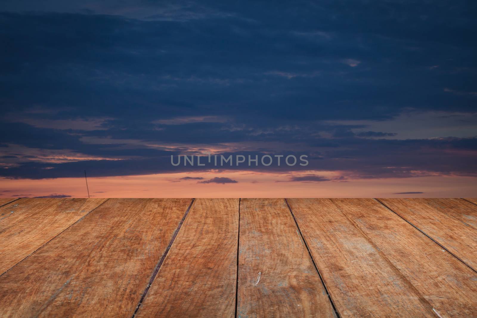 Perspective top wooden with sunrise on the lake by punsayaporn